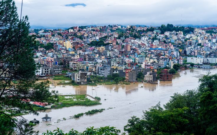High-angle view of a town with a swollen muddy river overflowing into nearby fields